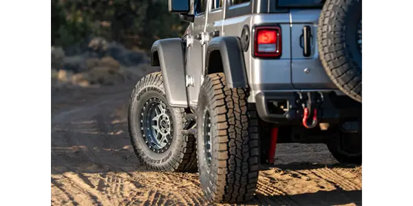 Silver Jeep with Open Range A/T Plus Tires