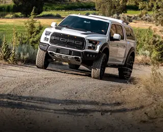 A white pickup on a gravel road
