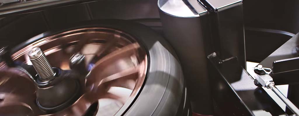 Road-force balancing machine with spinning tire.