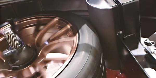 Road-force balancing machine with spinning tire.