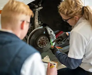 Les Schwab employee working on brakes
