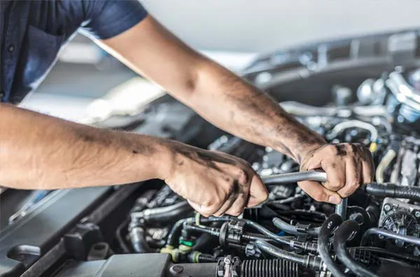 Mechanic working on a car engine