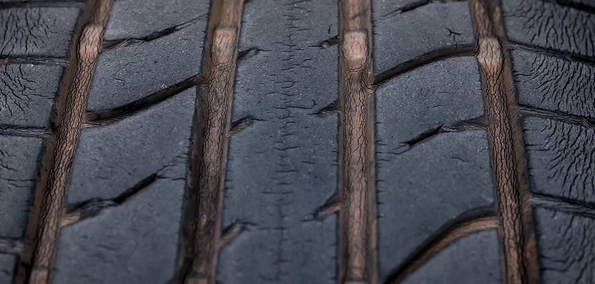Close-up of cracks appearing on the tire tread