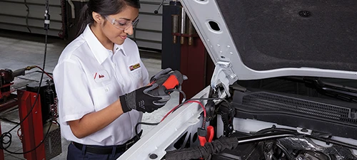 Technician checking a car battery