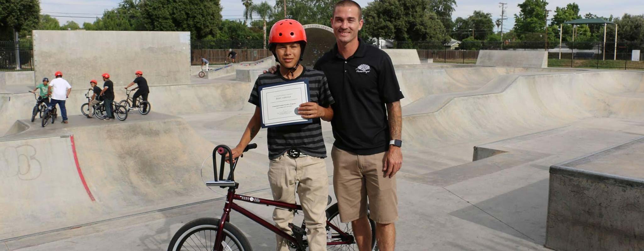 Brani Valencia and Tony Hoffman pose at a skatepark.