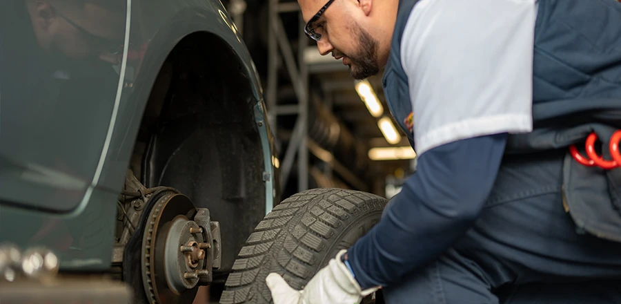 Les Schwab employee inspecting a vehicle