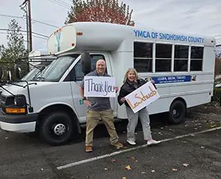 YMCA of Snohomish County employees in front of fleet vans