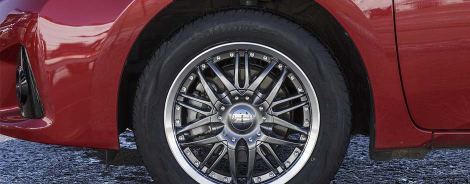 A Les Schwab employee installing all-season tires