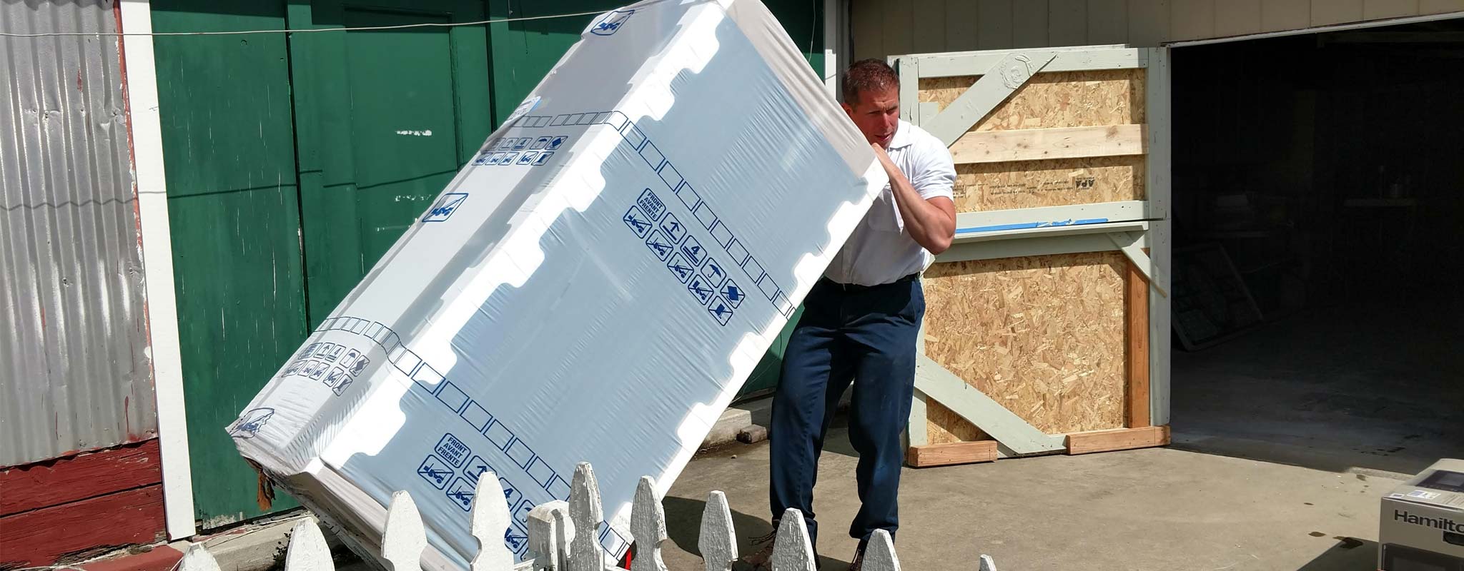 Les Schwab manager Brett Clark delivering a new fridge to the 4-H clubhouse.