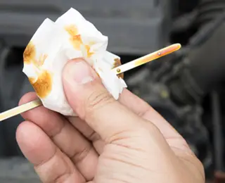 Checking oil with a dipstick