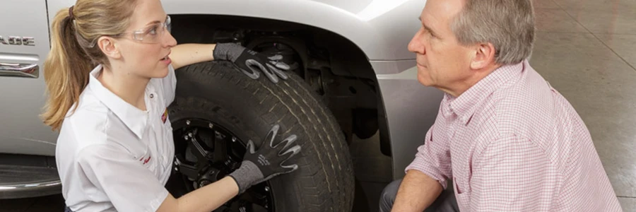 Les Schwab employee talks to a customer about their tires