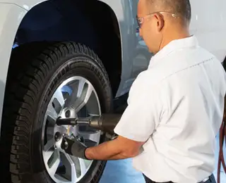 A Les Schwab technician performing a tire changeover