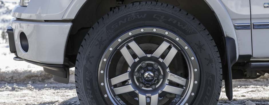 Winter snow tires on a snow covered car