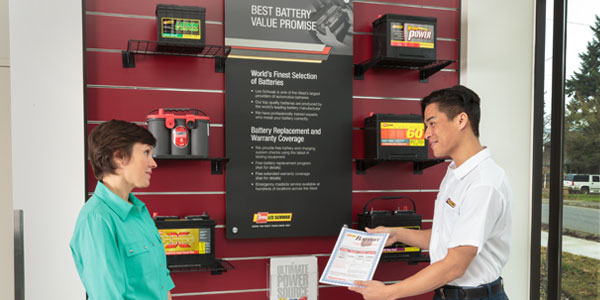  Les Schwab Tire Stores technician with battery customer