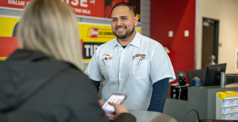 Les Schwab employee talking with a customer