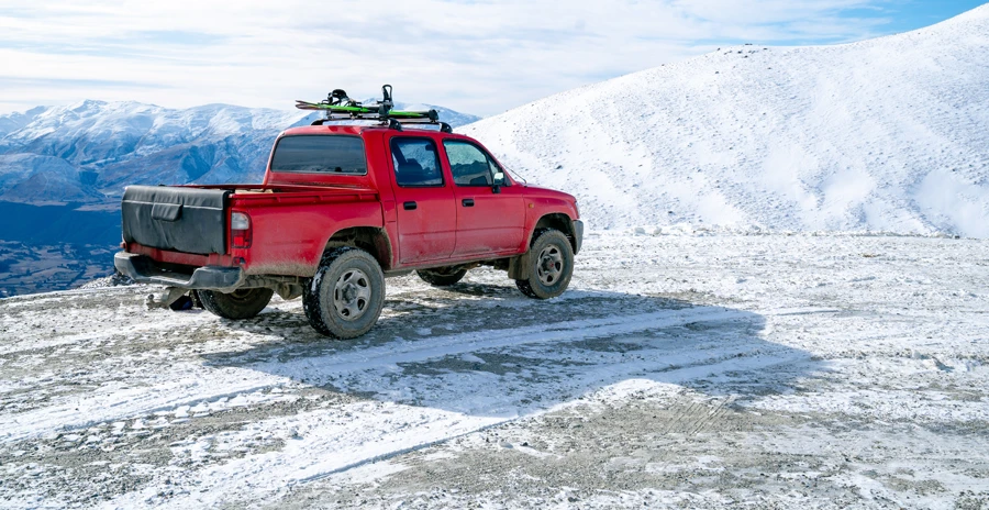 Truck parked on a mountaintop with snow