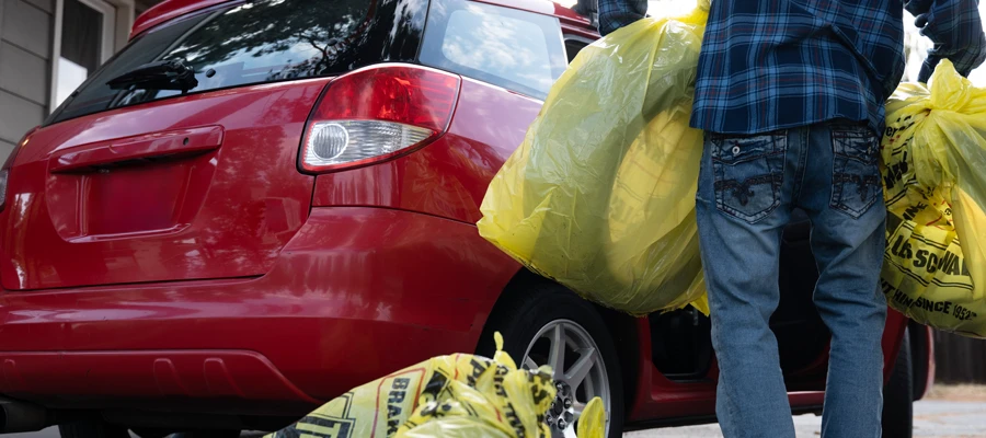 Les Schwab customer moving tires from a car to his garage