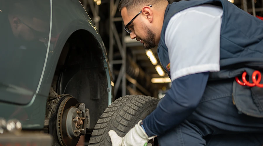 Les Schwab employee changing a tire