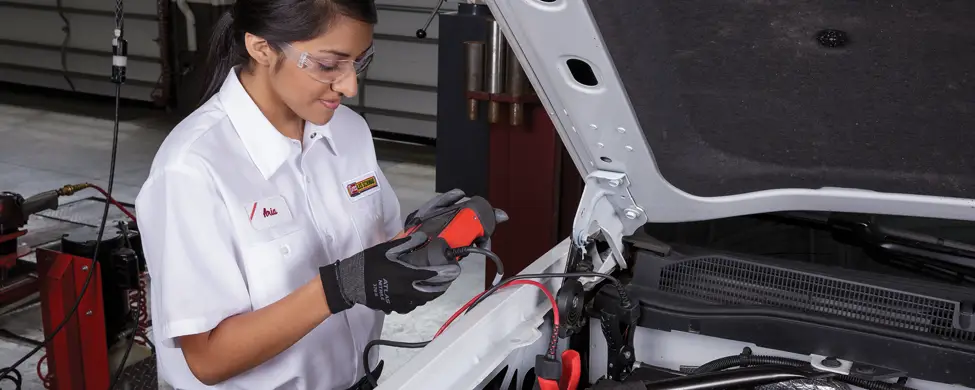 Les Schwab technician testing a battery