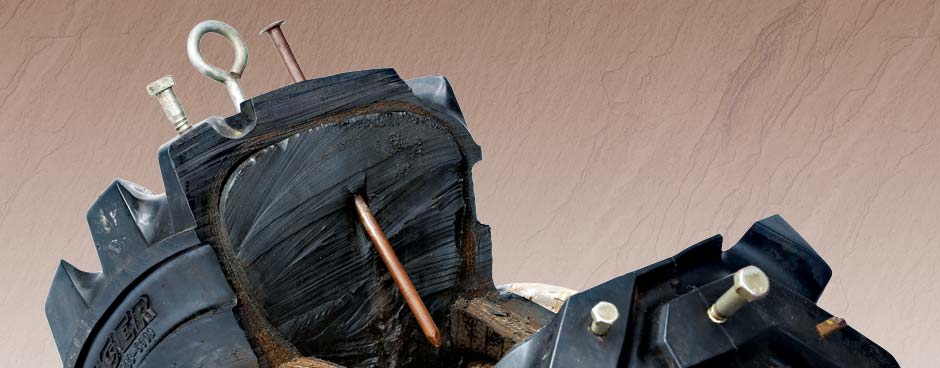 Commercial tire cutaway that shows the interior filled with flatproofing product and bolts.