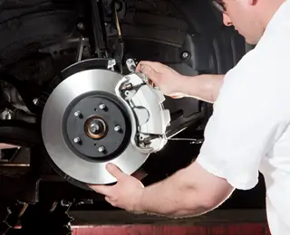 Les Schwab employee working on brakes