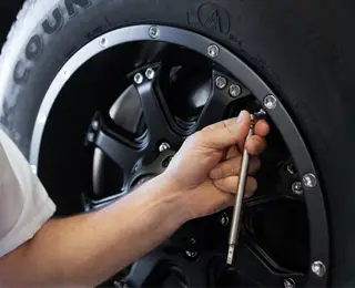 Les Schwab technician checking tire pressure