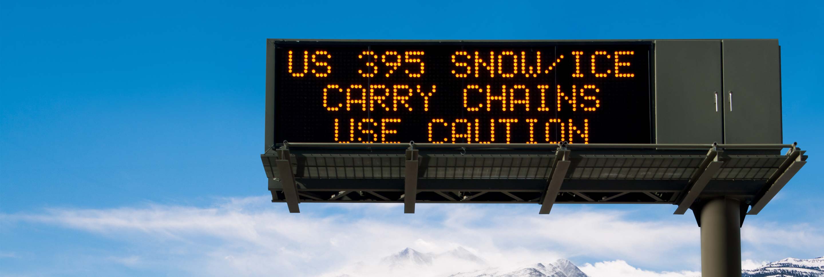 A highway sign warning of winter road conditions.