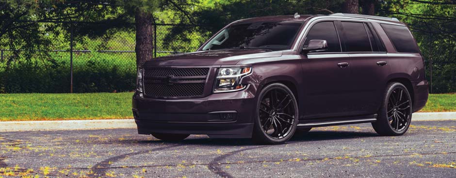 Compact car with lowered suspension on side of road