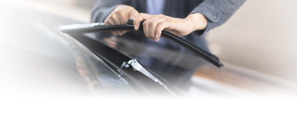 Person changing a windshield wiper blade
