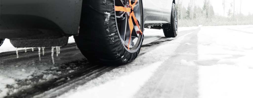 White SUV with tire sock installed on front tire