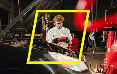 Les Schwab technician checking a battery