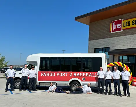 Fargo Post 2 American Legion Baseball van with Les Schwab employees