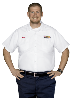 A Les Schwab technician stands arms akimbo. His name is Hunter